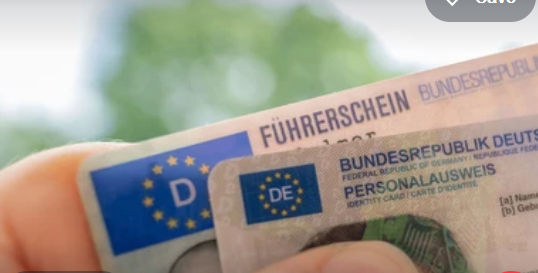 A hand holding a newly issued smart card Permanent Driving Licence.